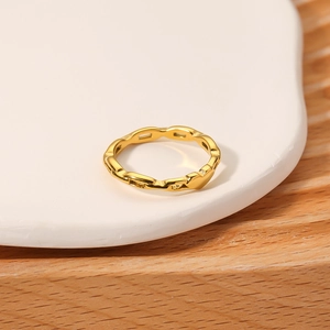 18K gold plated titanium steel ring with bamboo design on a ceramic display tray