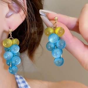 Detail of sky blue and lemon yellow beaded grape tassel earrings with gold ear hooks