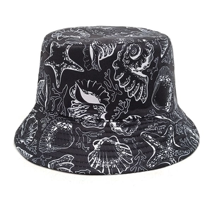 Detail of black bucket hat featuring white ocean patterns like starfish and seashells