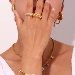Detailed view of model wearing gold-plated heart ring and matching jewelry set