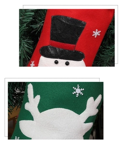 Close-up of handmade felt Christmas stockings with snowman and reindeer embroidery