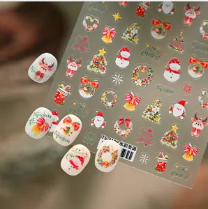 Close-up of watercolor Christmas nail decals featuring Santa, snowman and reindeer designs