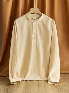 Close-up of beige linen shirt texture with 95% linen fabric and stand collar details