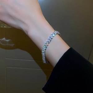 Close-up of elegant multi-layer silver plated bracelet with sparkling crystals on wrist