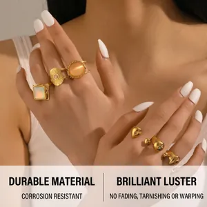 Detail of vintage 18K gold plated ring set featuring iridescent stones and sun patterns