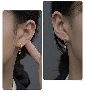 Detail of S925 silver hoop earrings with green teardrop and marquise gemstones