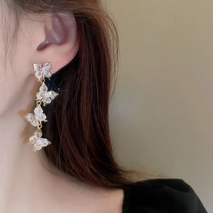 Elegant long tassel earrings featuring four cubic zirconia butterflies on a gold chain