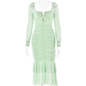 Detail of light green mesh dress showing pleated bodice with cut-out and elegant mermaid hem