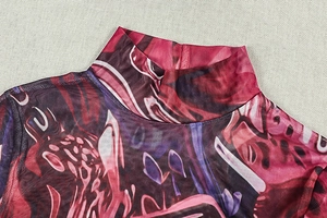 Detail view of the high mock neck and vibrant abstract print on sheer mesh fabric