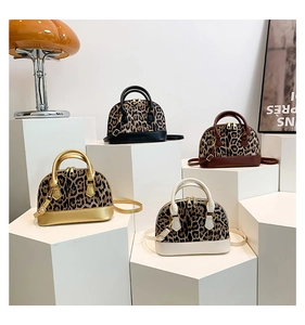 Collection of dome-shaped leopard print handbags with colorful trim and gold hardware