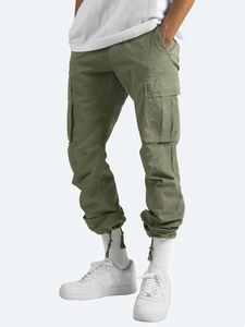 Detail view of olive green cargo pants with drawstring waist and functional side pockets