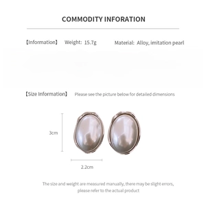 Detail view of oval pearl earrings with size dimensions and material information