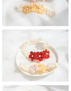 Detail of handmade baby headband with corduroy flowers, pearls and soft lace texture