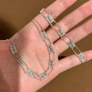 Vintage silver hollow flower double chain bracelet with delicate floral details and retro charm