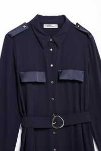 Detail of navy shirt dress featuring gold shoulder buttons and adjustable D-ring belt