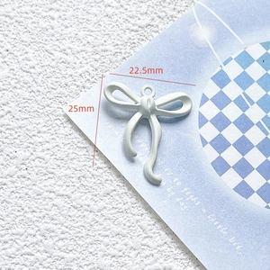 Detailed view of sea salt blue bow charm with dimensions 25mm by 22.5mm for DIY crafts