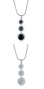 Detailed view of silver teardrop necklaces with black and clear cubic zirconia pendants