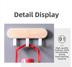 Detail of wooden wall-mounted triple hook showing strong load-bearing capacity for heavy items