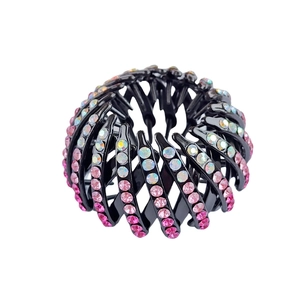 Detailed view of nest-shaped hair claw with sparkling pink and white rhinestones
