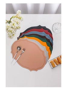 Detailed top view of irregular PU leather placemats in seven vibrant assorted colors