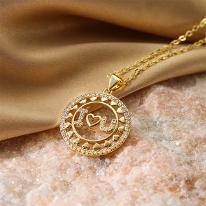 Macro view of gold heart pendant with I Love You engraving on silk and stone background