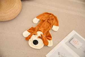 Flat lay of a plush brown and white dog-themed onesie for kids with cartoon character hood