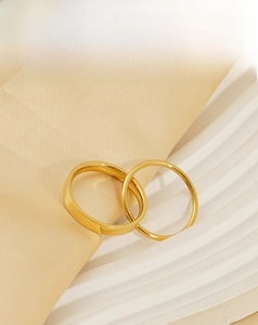 Detailed view of interconnected 18k gold plated stainless steel double band rings