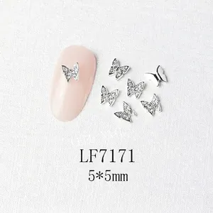 Detailed view of silver butterfly nail charms with rhinestones and 5x5mm dimensions