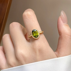 Elegant 18k gold plated ring featuring an oval olive green zircon with white diamond halo