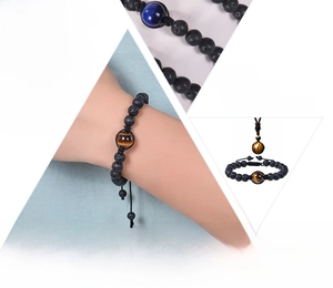Detailed view of adjustable tiger eye and volcanic stone beaded bracelet set on wrist