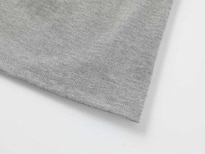 Detail of grey modal knit fabric showing double-needle flat stitch on the sleeve hem
