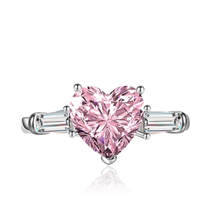 Luxury heart-shaped pink zircon ring with baguette-cut side stones on white background