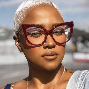 Close-up of oversized red cat-eye glasses frame with sparkling glitter finish for women