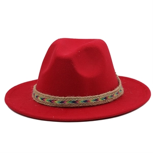 Detail of red wool felt fedora featuring a colorful woven ethnic style decorative band