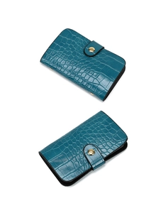 Detail of dark teal faux crocodile leather card holder with golden snap button closure