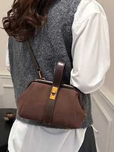 Retro dark brown shell handbag with gold hardware clasp and premium suede texture