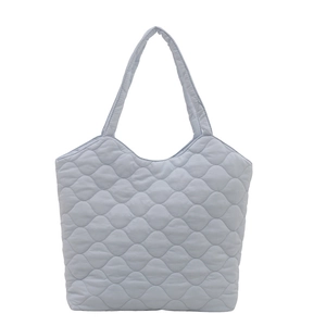 Light blue quilted down tote bag with diamond stitching and puffer shoulder straps