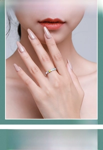 Close-up of S925 silver ring featuring colorful enamel heart charms on a model finger