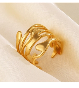 Detail of gold multi-layer wavy lava ring showing metallic texture on silk background