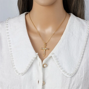 Elegant gold cross necklace with colorful zircon stones on woman with lace collar