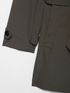 Detail shot of charcoal grey windproof jacket featuring buckle cuffs and woven fabric texture