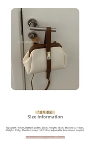 Close-up of contrast color crossbody bag with retro metal clasp hanging on door handle