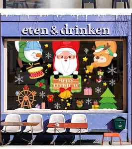 Close-up of Santa Claus and reindeer window stickers on a store glass storefront