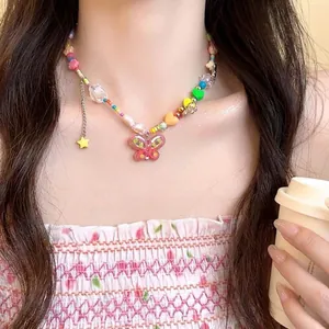 Close-up of colorful heart and butterfly beaded necklace worn by a fashion model