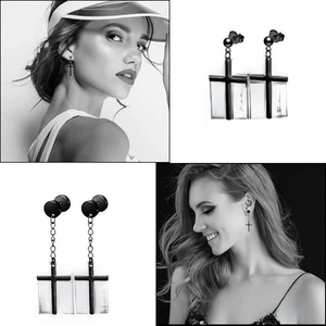 Detail view of black stainless steel cross earrings for men and women in punk style