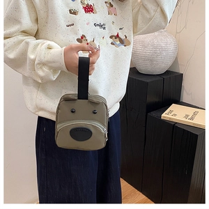 Close-up of cute cartoon bear handbag with 3D ears and durable wide nylon strap