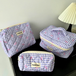 Three-piece gingham toiletry bag set with quilted finish and pink bow patterns