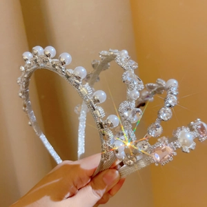 Detail of silver pearl headbands with sparkling rhinestones and pink crystals