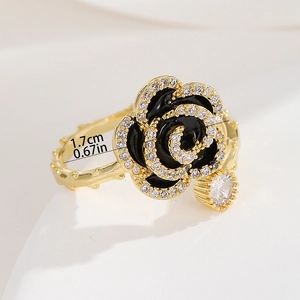 Detail showing 1.7cm black enamel flower ring with zircon edging and golden thorn band