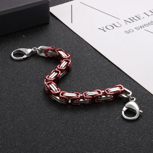 Detail of two-tone red and silver Byzantine style steel bracelet with lobster clasp